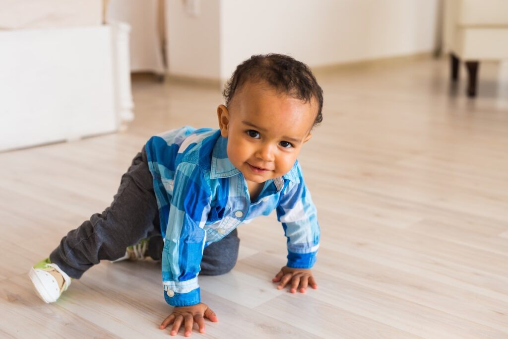 Baby exploring movement while crawling on hands and knees