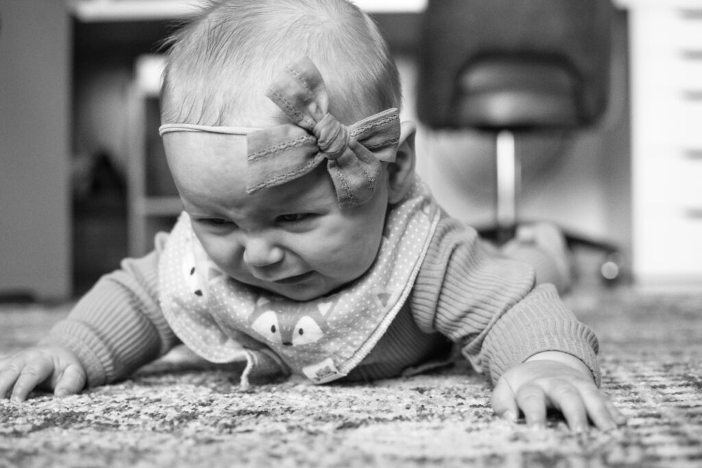 Premature baby practicing tummy time on the floor