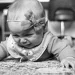 Premature baby practicing tummy time on the floor